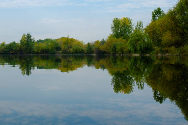 istock Autumn forest reflected in water. Colorful autumn landscape. 1044671708