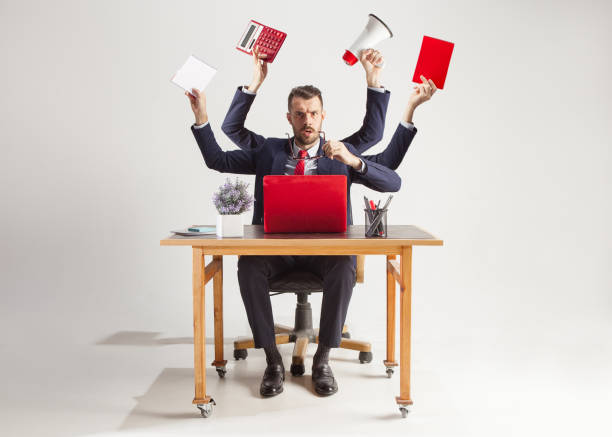 istock businessman with many hands in elegant suit working with paper, document, contract, folder, business plan. 1044672100