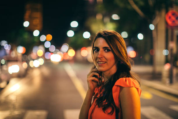 istock Elegant woman using cell phone outdoor 1044675172