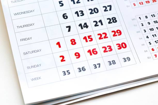 istock White calendar. Weekends are highlighted in red. Close up 1044675546