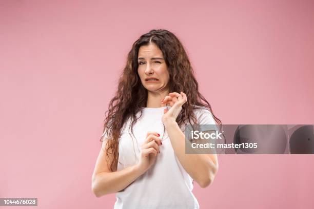 Young Woman With Disgusted Expression Repulsing Something Isolated On The Pink Stock Photo - Download Image Now