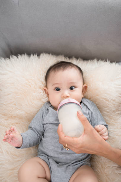 istock Young mother is feeding her baby at room 1044682148