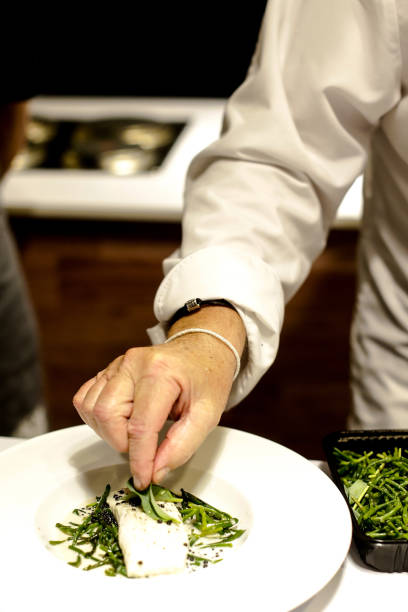 istock Chef preparing food, meal, in the kitchen, chef cooking, Chef decorating dish, closeup, chef at work 1044682660