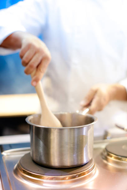 istock Chef preparing food, meal, in the kitchen, chef cooking, Chef decorating dish, closeup, chef at work 1044682664