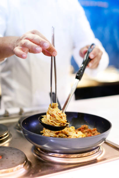 istock Chef preparing food, meal, in the kitchen, chef cooking, Chef decorating dish, closeup, chef at work 1044682674