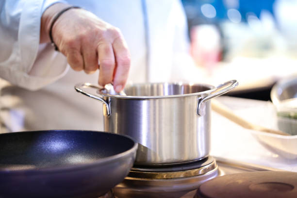 istock Chef preparing food, meal, in the kitchen, chef cooking, Chef decorating dish, closeup, chef at work 1044682690