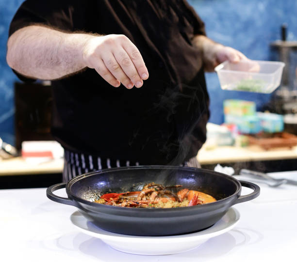 istock Chef preparing food, meal, in the kitchen, chef cooking, Chef decorating dish, closeup, chef at work 1044682706