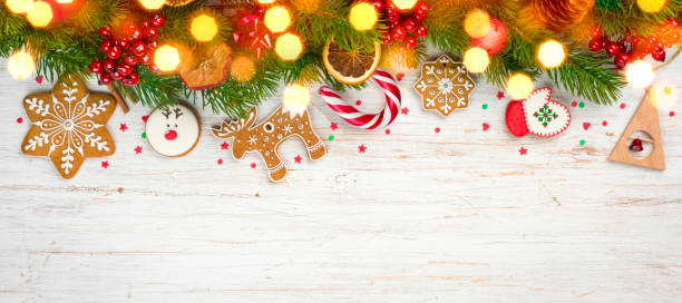istock Glittered hristmas background, decorated holiday tree branches and gingerbread cookies 1044689084