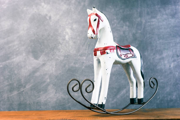 istock Toy rocking white horse on a dark background, close up. 1044689136