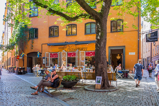 Stockholm, Sweden - 8/7/2018: Tourists in cafe and Stortorget square in Stockholm