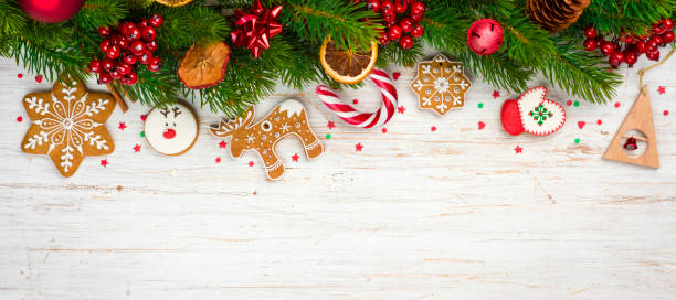 Christmas background concept, decorated holiday tree branches and gingerbread cookies