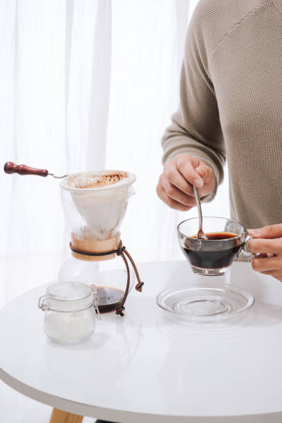 istock Young man enjoying coffee and breakfast at a cafe 1044692224