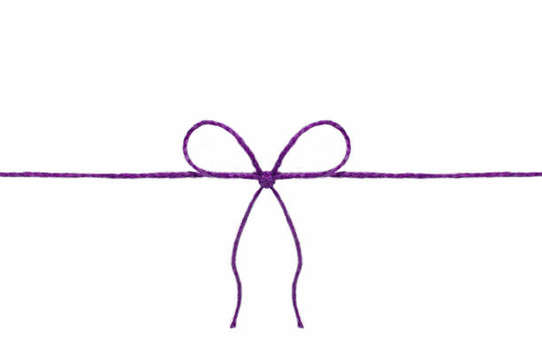 istock Purple rope with a bow on the middle isolated on a white background 1044697616
