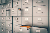 Filing cabinet with yellow folders in an open drawers