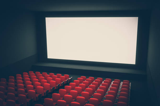 istock Cinema auditorium with white blank screen and red seats 1044703774