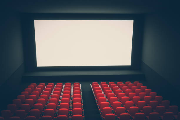istock Cinema auditorium with white blank screen and red seats 1044704166