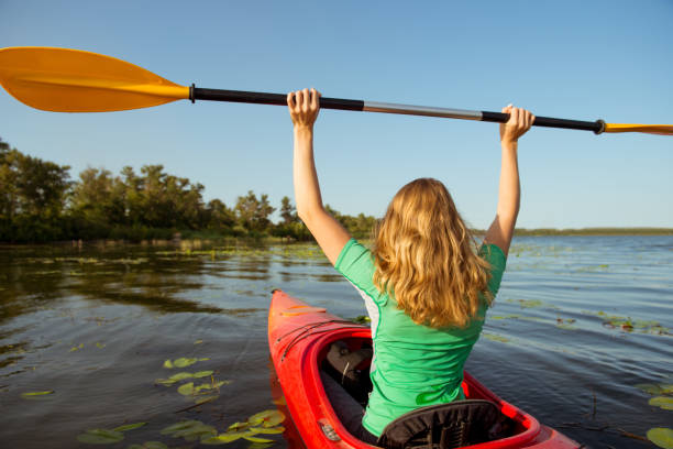 istock Woman in a kayak on a river with a raised oar 1044706706