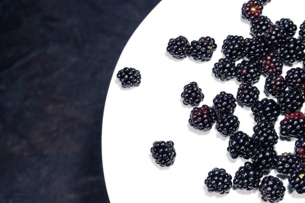 istock Blackberry on a white wooden round table 1044708094