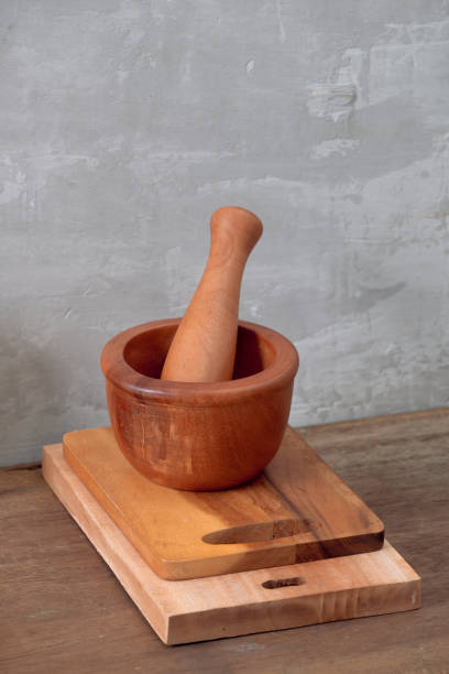 istock Kitchen tools for cooking on a wooden table on the background of a concrete wall. Copy space 1044708430