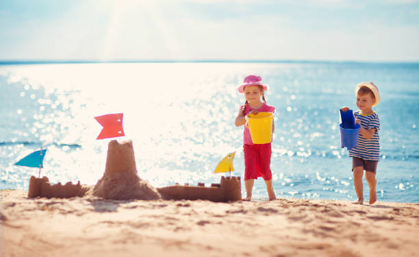 istock Boy and girl playing on the beach 1044708814