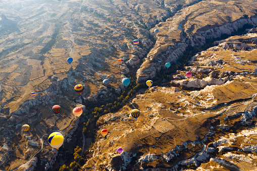 istock Aerial view of hot air balloons flying over Cappadocia at sunrise，Turkey 1044721638
