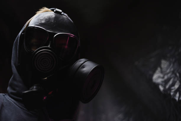 istock Man in a gas mask dark background 1044722148
