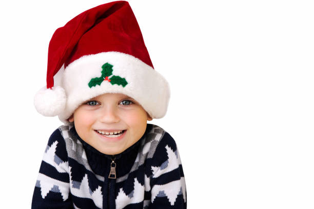 istock A boy in a Christmas hat isolated on a white background 1044722162