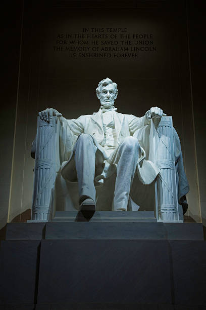 Indoor Lincoln Memorial statue in seated pose lit from above Statue of Abraham Lincoln in the Lincoln Memorial, Washington, D.C. washington dc slavery the mall lincoln memorial stock pictures, royalty-free photos & images