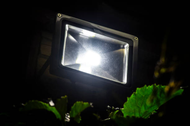LED garden spotlight Garden LED spotlight on a wooden building close-up. searchlight photos stock pictures, royalty-free photos & images