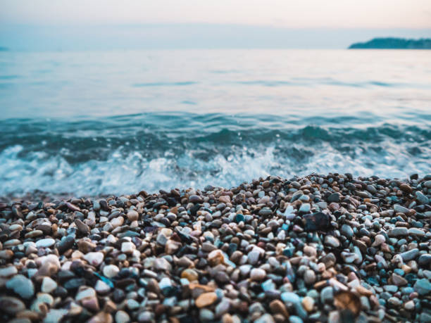 wet pebble stones and small waves at the beach