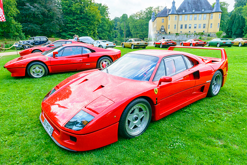 Ferrari F40 supercar and Ferrari 288 GTO at a classic car show. This  red Ferrari F40 is fitted with a bi-turbo V8 and was the former car of Formula 1 driver Nigel Mansell. The car is on display during the 2017 Classic Days event at Schloss Dyck.