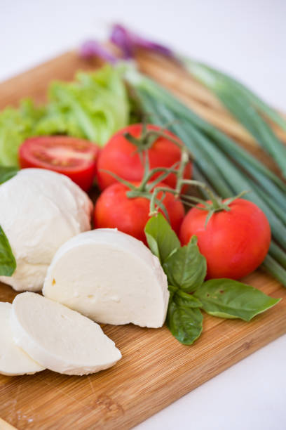 istock Homemade Organic Mozzarella Cheese with Tomato and Basil and onions. 1044736618
