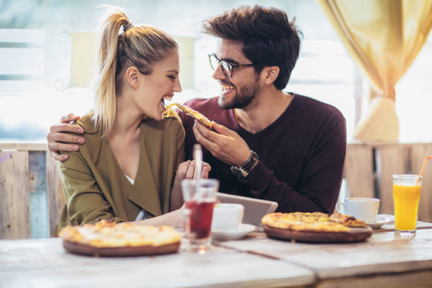 istock Smiling couple enjoying in pizza, having fun together. 1044742566