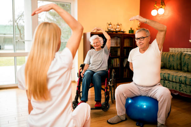 istock Physiotherapist shows exercise to senior couple 1044743478