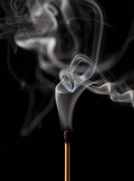 istock Smoking matchstick, just extinguished, on dark background 1044743966