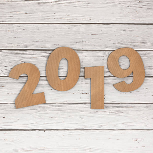 istock Cardstock Numbers 2019 Happy New Year Sign over table. 3d Rendering 1044743984