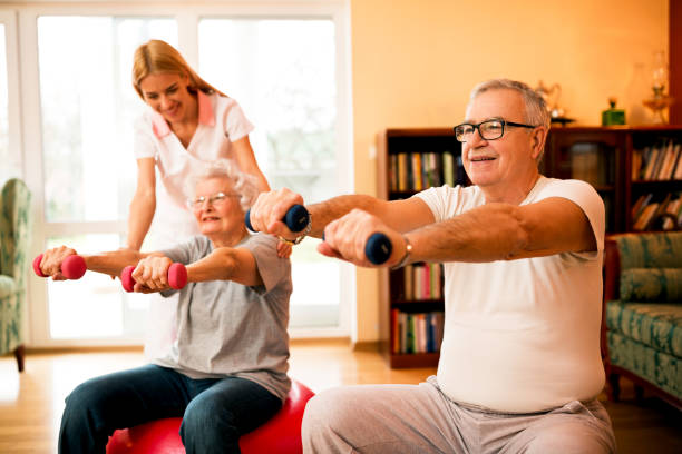 istock Nurse at nursing home helps senior people to doing exercises 1044748194