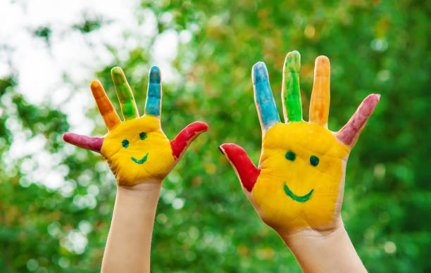 istock children hands in colors. Summer photo. Selective focus. 1044754290