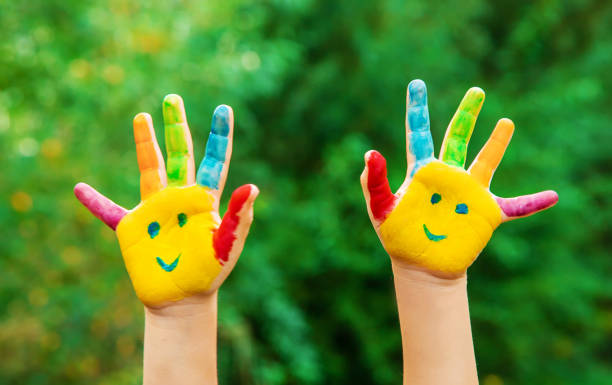 children hands in colors. summer photo. selective focus. - spring child green small imagens e fotografias de stock