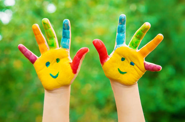 istock children hands in colors. Summer photo. Selective focus. 1044755752