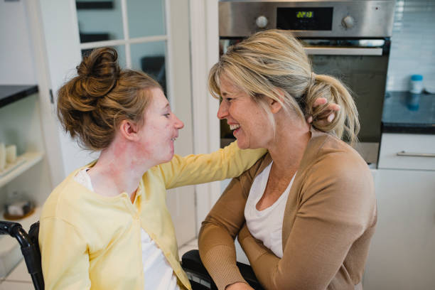 Mother Relaxing with Disabled Daughter at Home