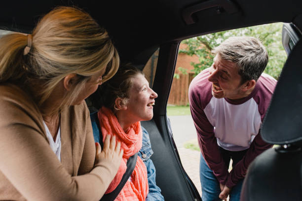 istock Parents Getting Disabled Daughter in the Car 1044762236