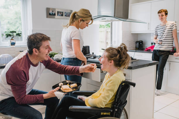 istock Family with Disabled Daughter in Kitchen at Home 1044762498
