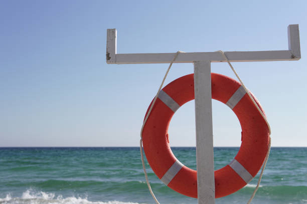 istock lifebuoy waves at the beach z q 1044763630
