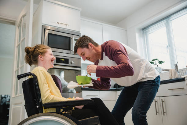Father Feeding Disabled Daughter at Home
