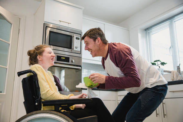istock Father Feeding Disabled Daughter at Home 1044763858