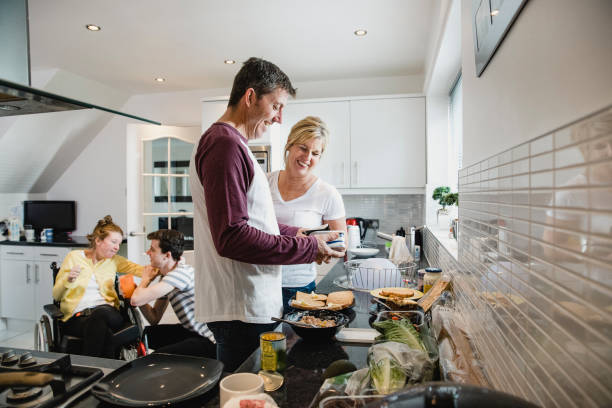 istock Parents Making Lunch While Son Cares for Disabled Daughter 1044764160