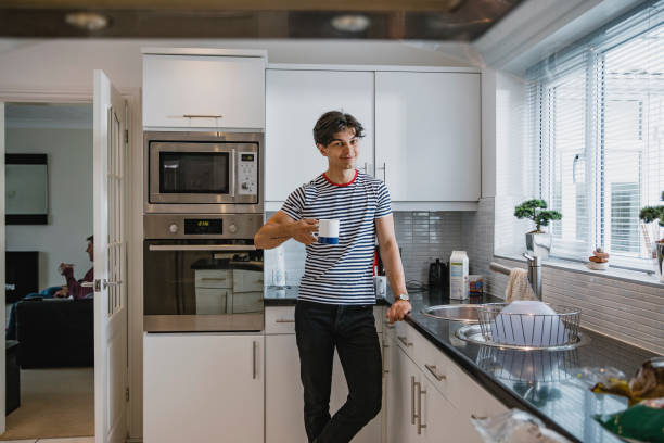 istock Young Man Enjoying a Cup of Tea at Home 1044764556