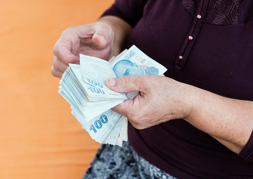 Senior woman counting Turkish lira banknotes, Close up