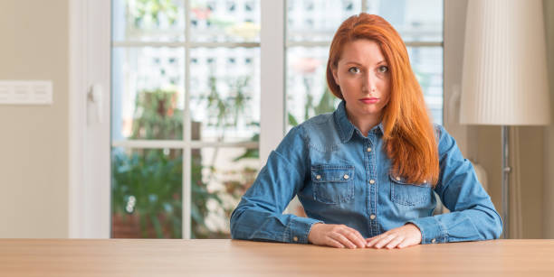 istock Redhead woman at home depressed and worry for distress, crying angry and afraid. Sad expression. 1044767876